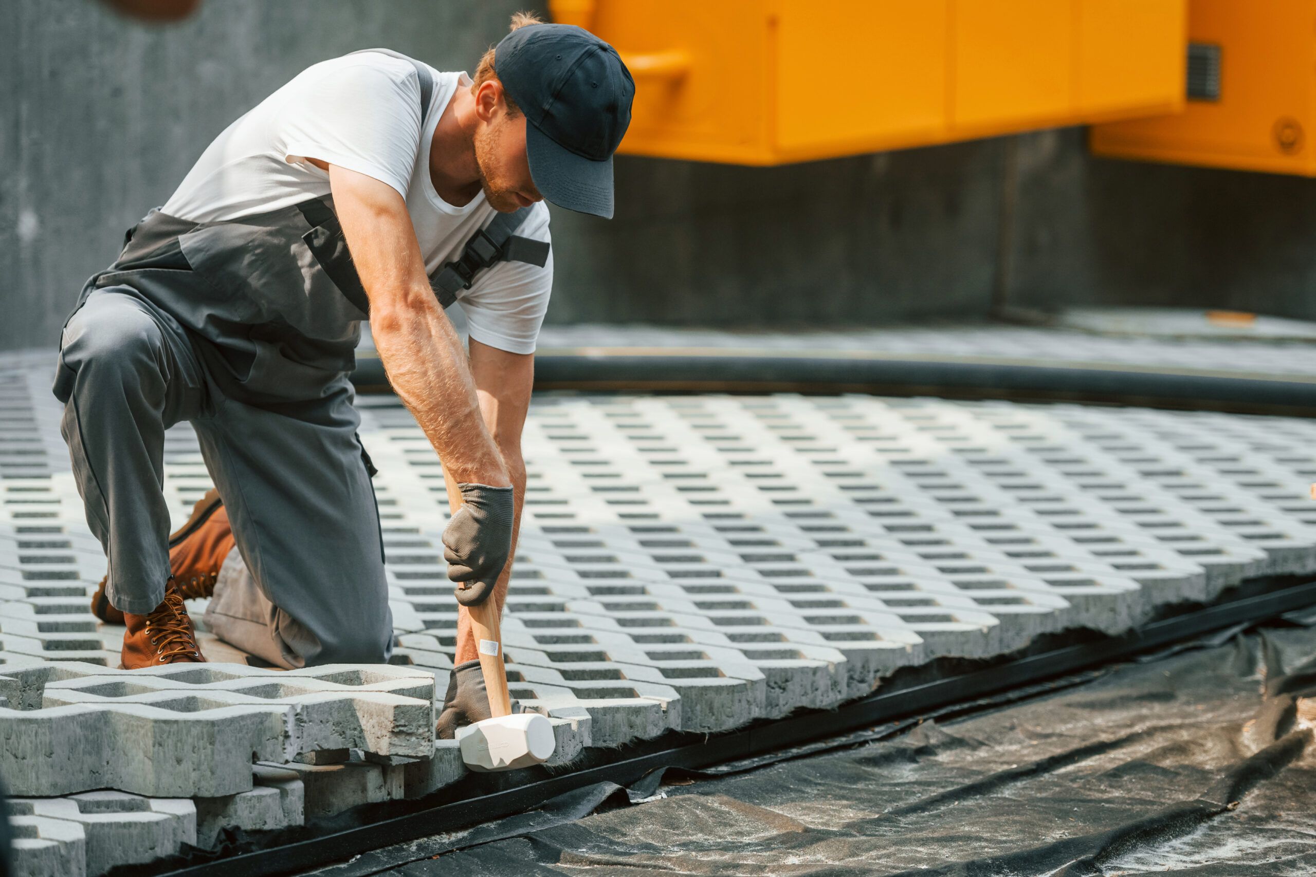 Job outdoors. Young man working in uniform at construction at daytime